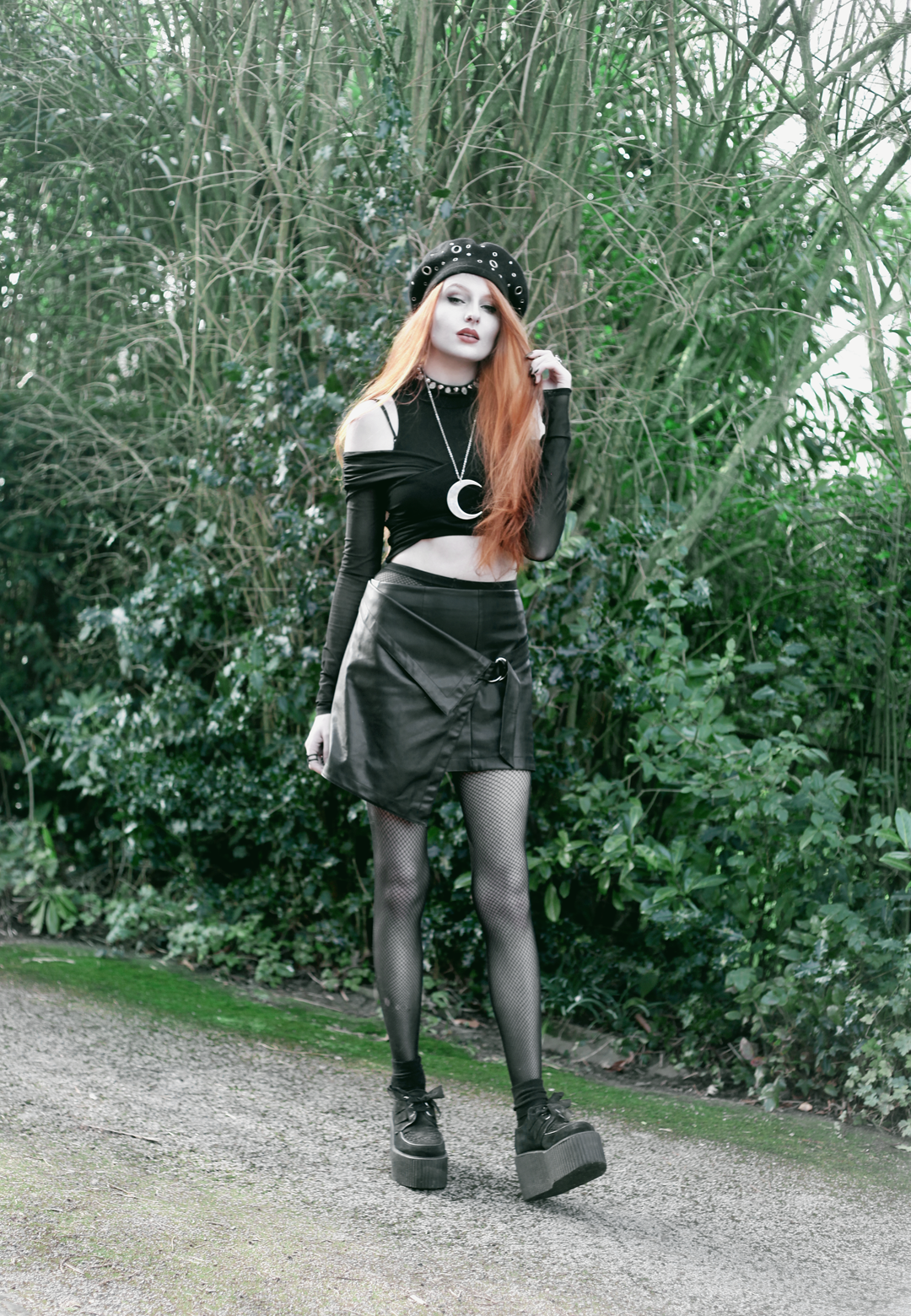 Olivia Emily wears Asos Eyelet beret, Killstar Luna Moon Necklace, Yayer high neck crop top under Asos Tall mesh off the shoulder wrap top, Vintage baseball jacket, asos faux leather wrap skirt & Underground triple sole creepers