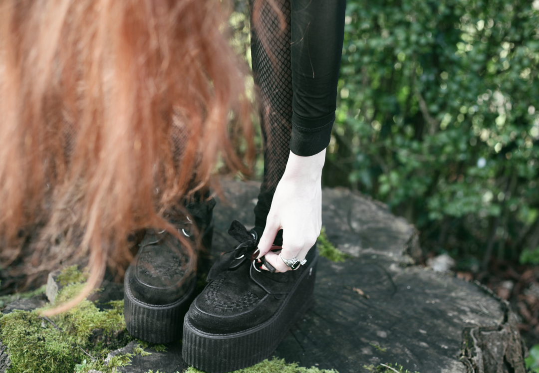 Olivia Emily wears Asos Eyelet beret, Killstar Luna Moon Necklace, Yayer high neck crop top under Asos Tall mesh off the shoulder wrap top, Vintage baseball jacket, asos faux leather wrap skirt & Underground triple sole creepers