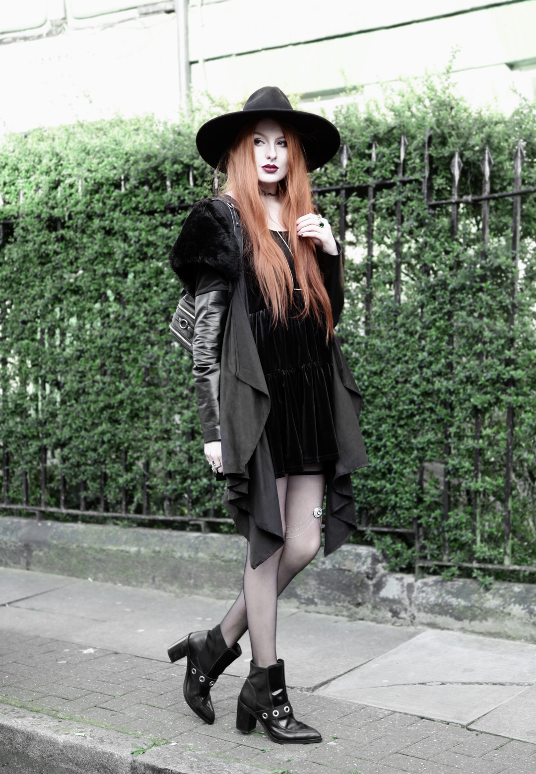 Olivia Emily wears Asos Reclaimed Vintage tiered black velvet dress, Killstar Witch Brim hat, Sanctus Asylum vegan suede coat, River Island leg chain, Asos eyelet boots