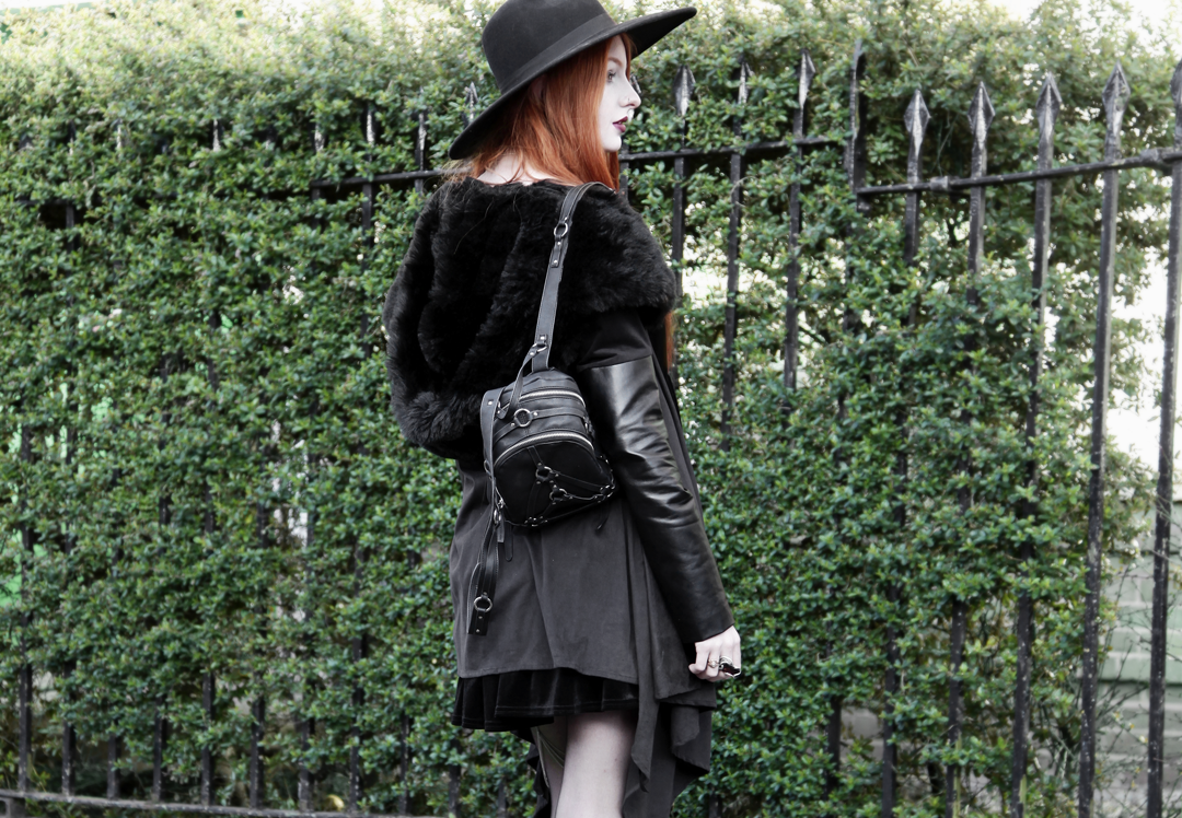 Olivia Emily wears Asos Reclaimed Vintage tiered black velvet dress, Killstar Witch Brim hat, Sanctus Asylum vegan suede coat and Unif Bound Mini backpack