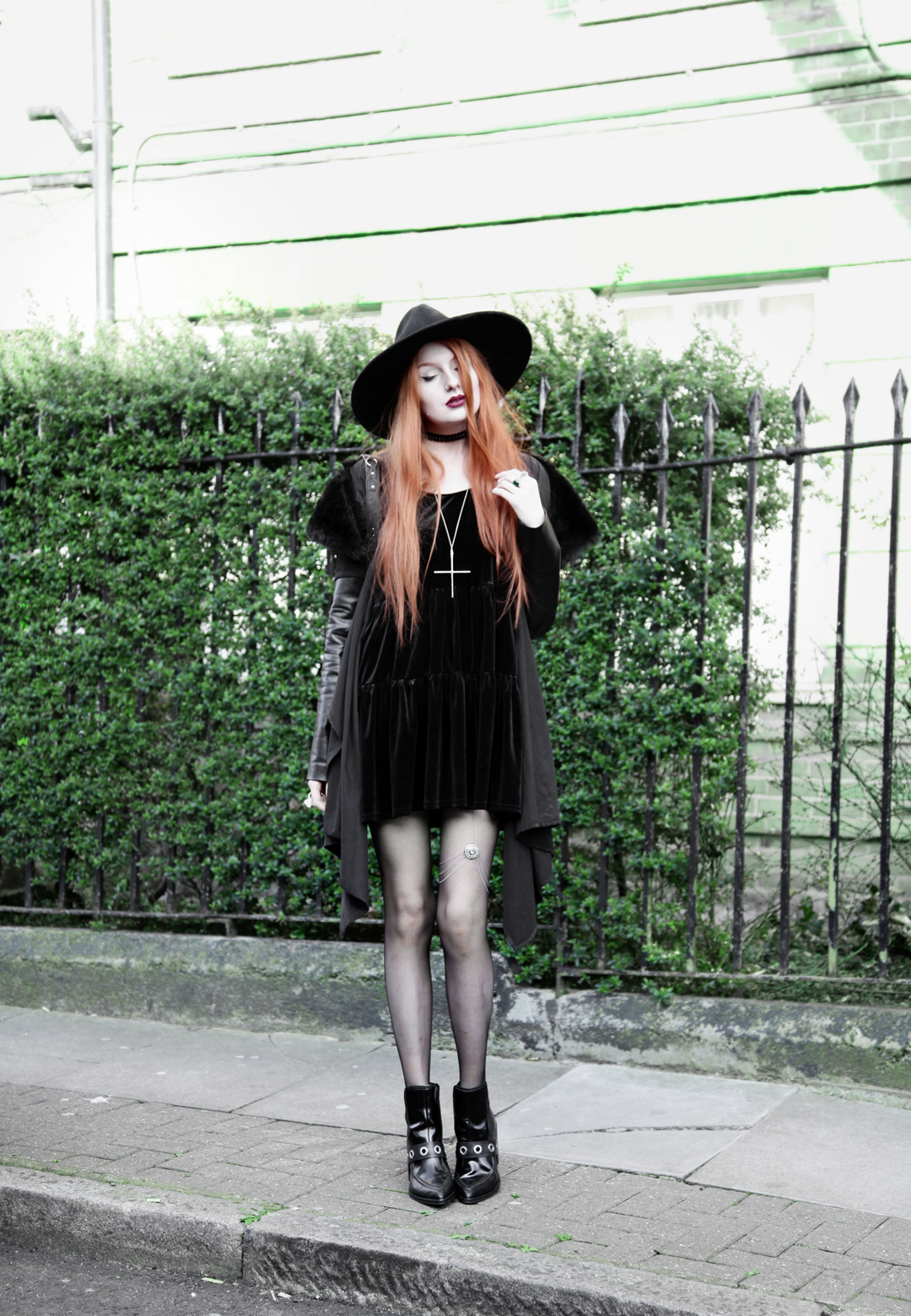 Olivia Emily wears Asos Reclaimed Vintage tiered black velvet dress, Killstar Witch Brim hat, Sanctus Asylum vegan suede coat, River Island leg chain and Asos eyelet boots