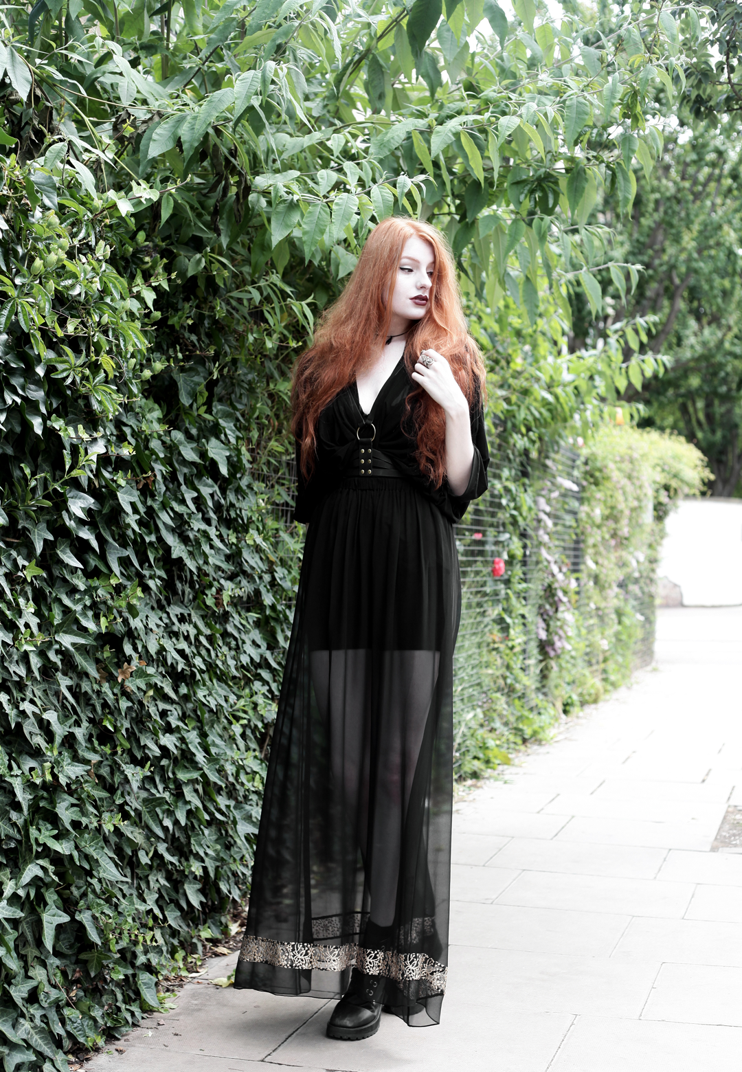 Olivia Emily wears Killstar Mesh Top, Dark Thorn Chastity Sheer Maxi Skirt, Asos Harness and Unif Dedi Boots