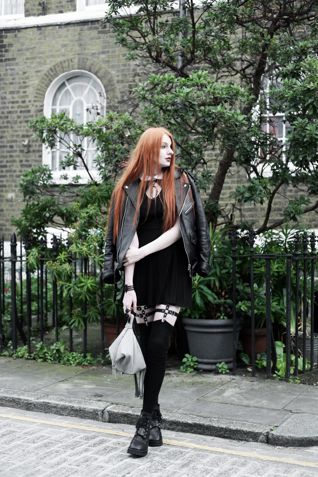 Olivia Emily wears Regalrose Pressed Flower 'Mourner' Choker, Killstar 'Bad Habits' Dress, Jakimac thigh harnesses, Rebecca Minkoff Backpack, Asos socks, and Unif Dedi Boots