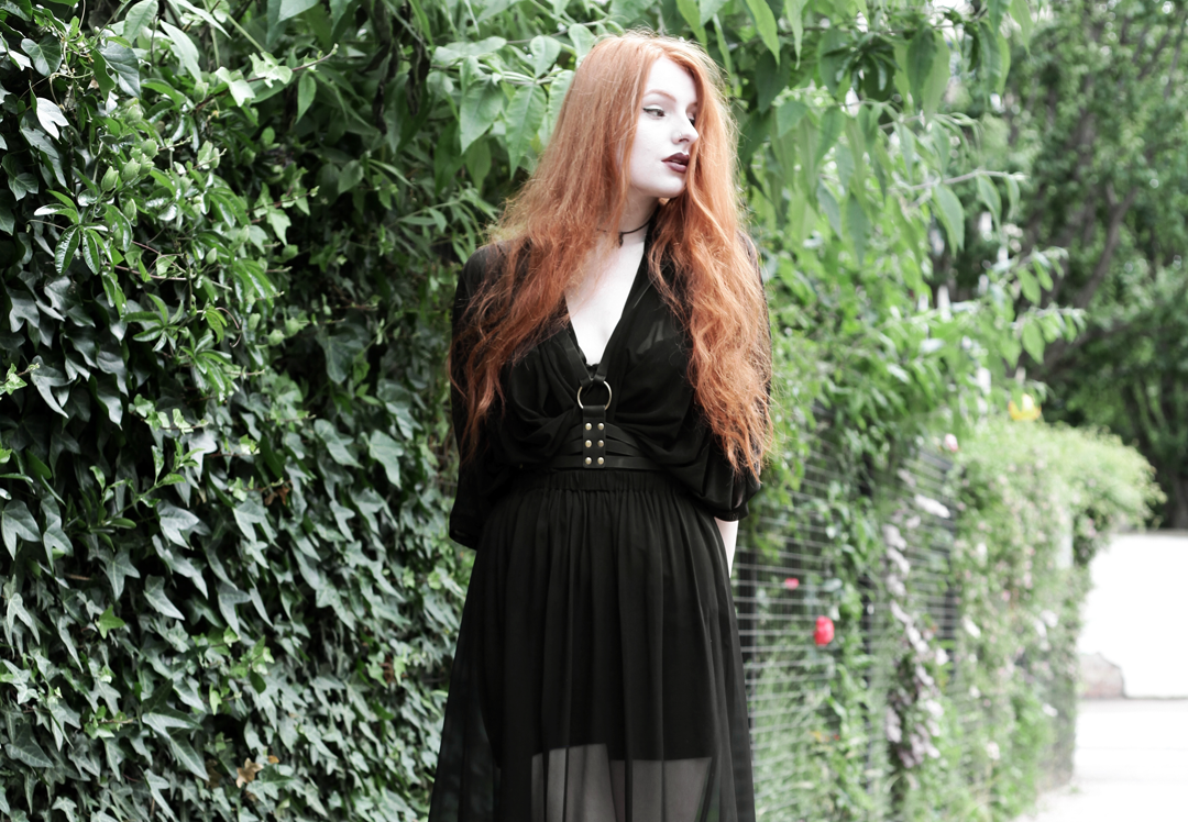 Olivia Emily wears Killstar Mesh Top, Dark Thorn Chastity Sheer Maxi Skirt, Asos Harness and Rogue and Wolf Choker