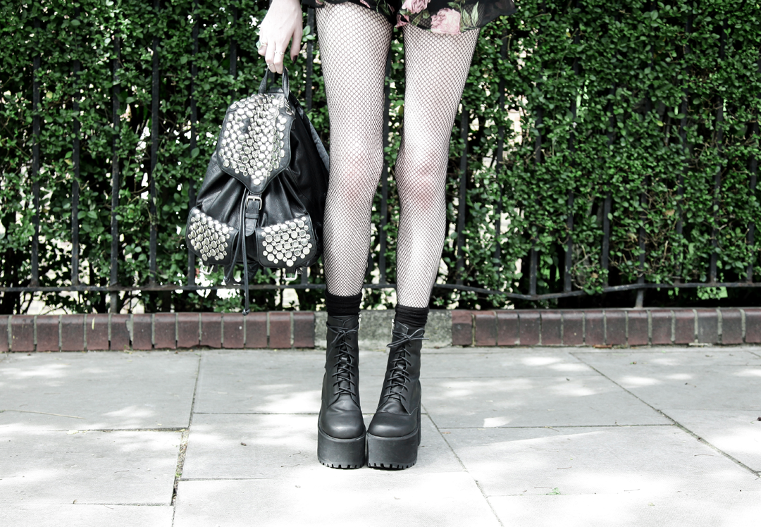 Olivia Emily wears Asos Band Of Gypsies playsuit, Rebecca Minkoff studded backpack, and Unif Scosche boots
