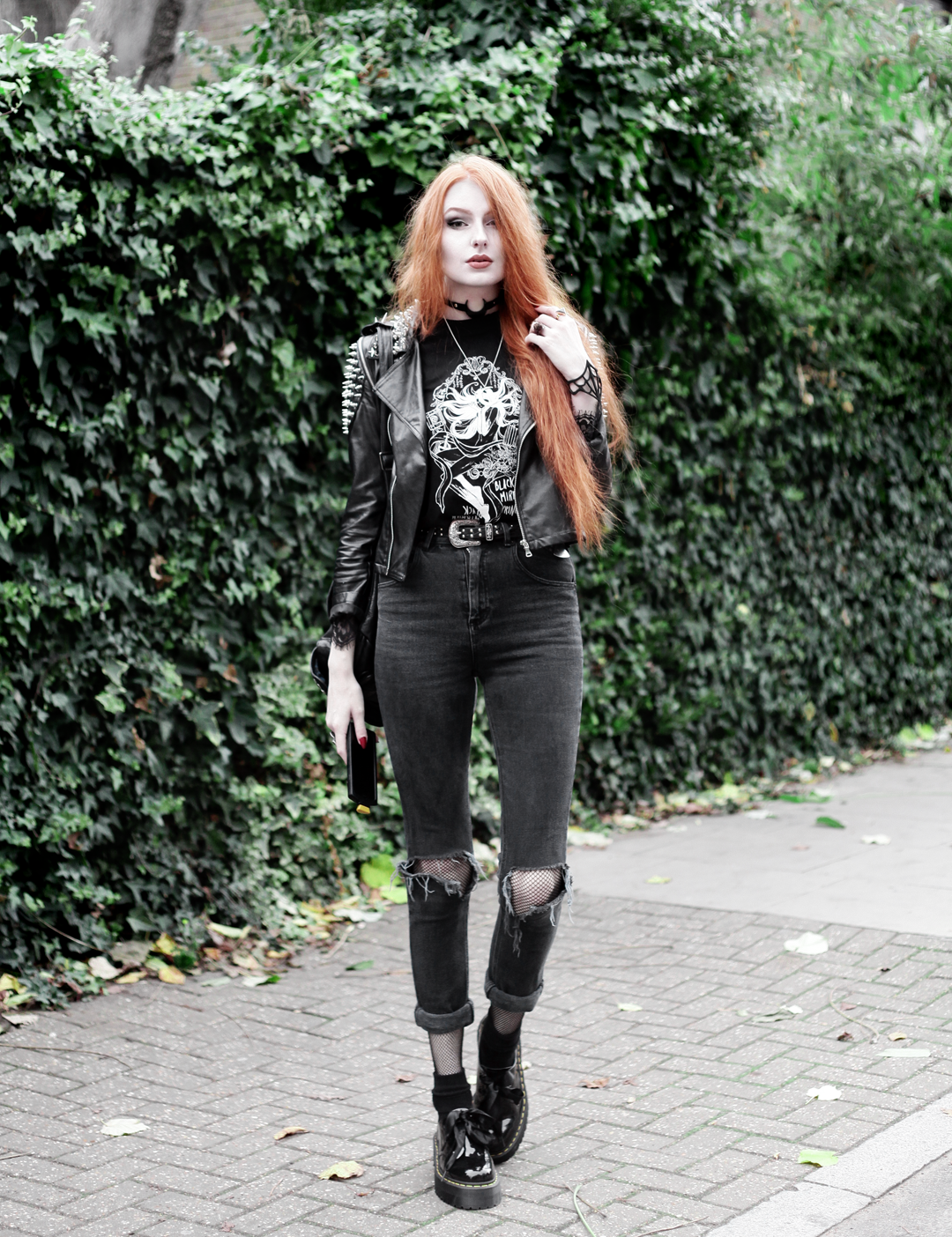 Olivia Emily wears Studded Biker Jacket, CosQueen Black Mirror Princess Tee, Asos Western Belt, Asos High Waisted Ripped Jeans, Dr Martens Patent Holly Shoes