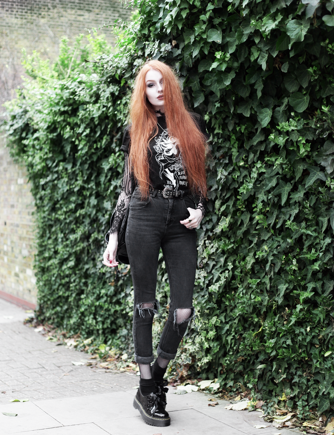 Olivia Emily wears CosQueen Black Mirror Princess Tee, Motel Black Lace Top, Asos Western Belt, Asos High Waisted Ripped Jeans, Dr Martens Patent Holly Shoes