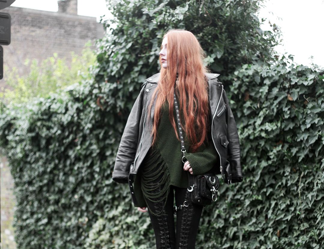 Olivia Emily wears Biker Jacket, Asos Bones Oversized jumper, Restyle pl harness bag, and Stylestalker lace up leggings trousers