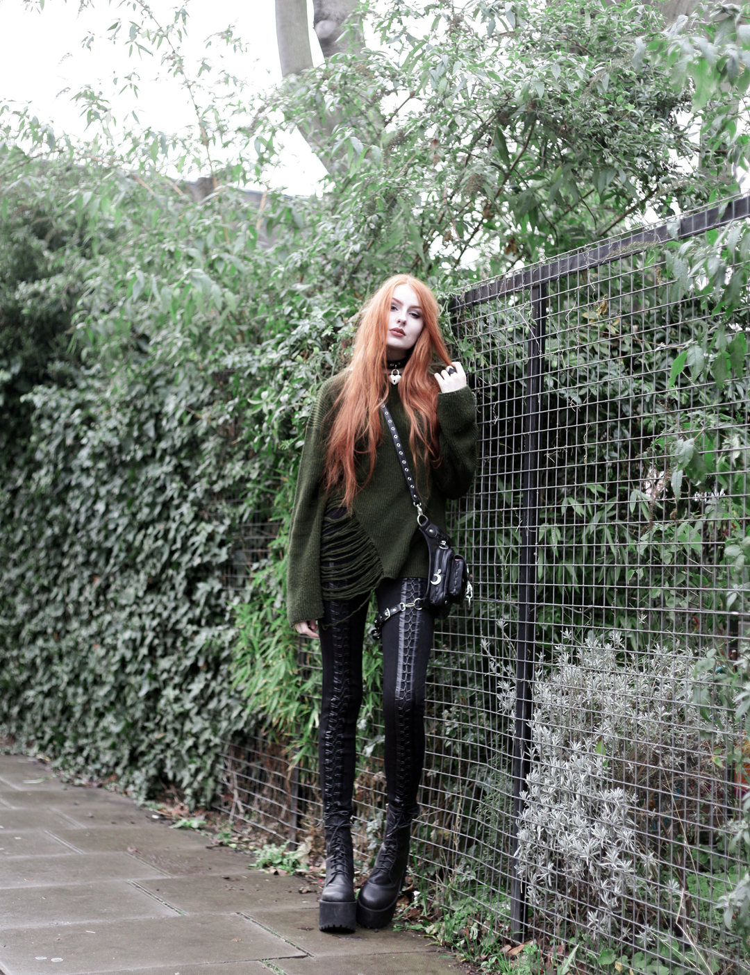 Olivia Emily wears Asos Bones Oversized jumper, Restyle pl harness bag, Stylestalker lace up leggings trousers, and Unif scosche boots