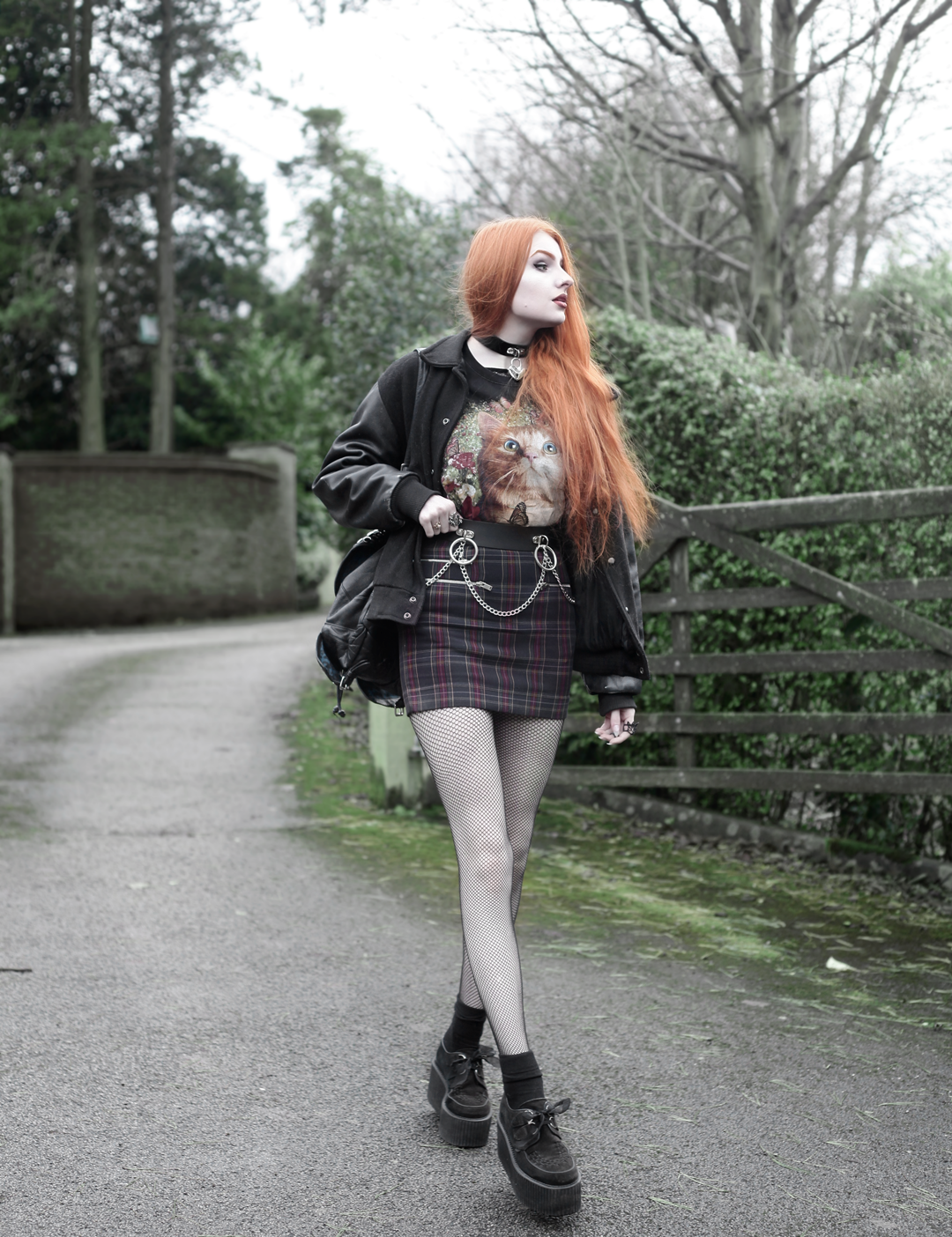 Olivia Emily wears Vintage Cat Tee, fishnet long sleeve top, Mary Wyatt Belt, Plaid Skirt, and Underground Creepers