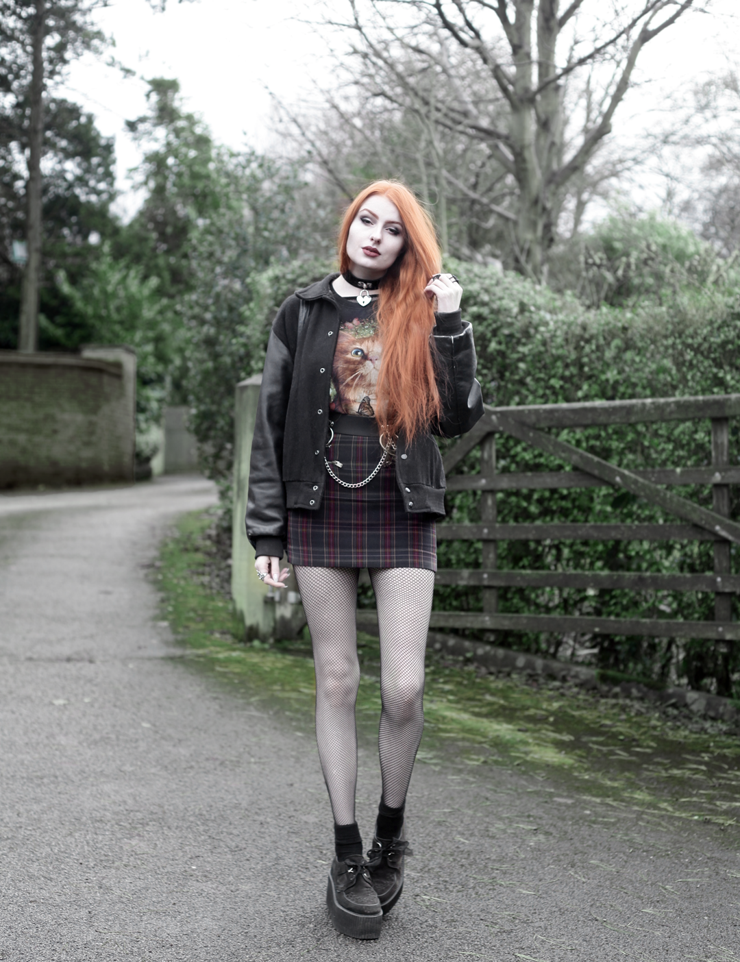 Olivia Emily wears Vintage Cat Tee, fishnet long sleeve top, Mary Wyatt Belt, Plaid Skirt, and Underground Creepers