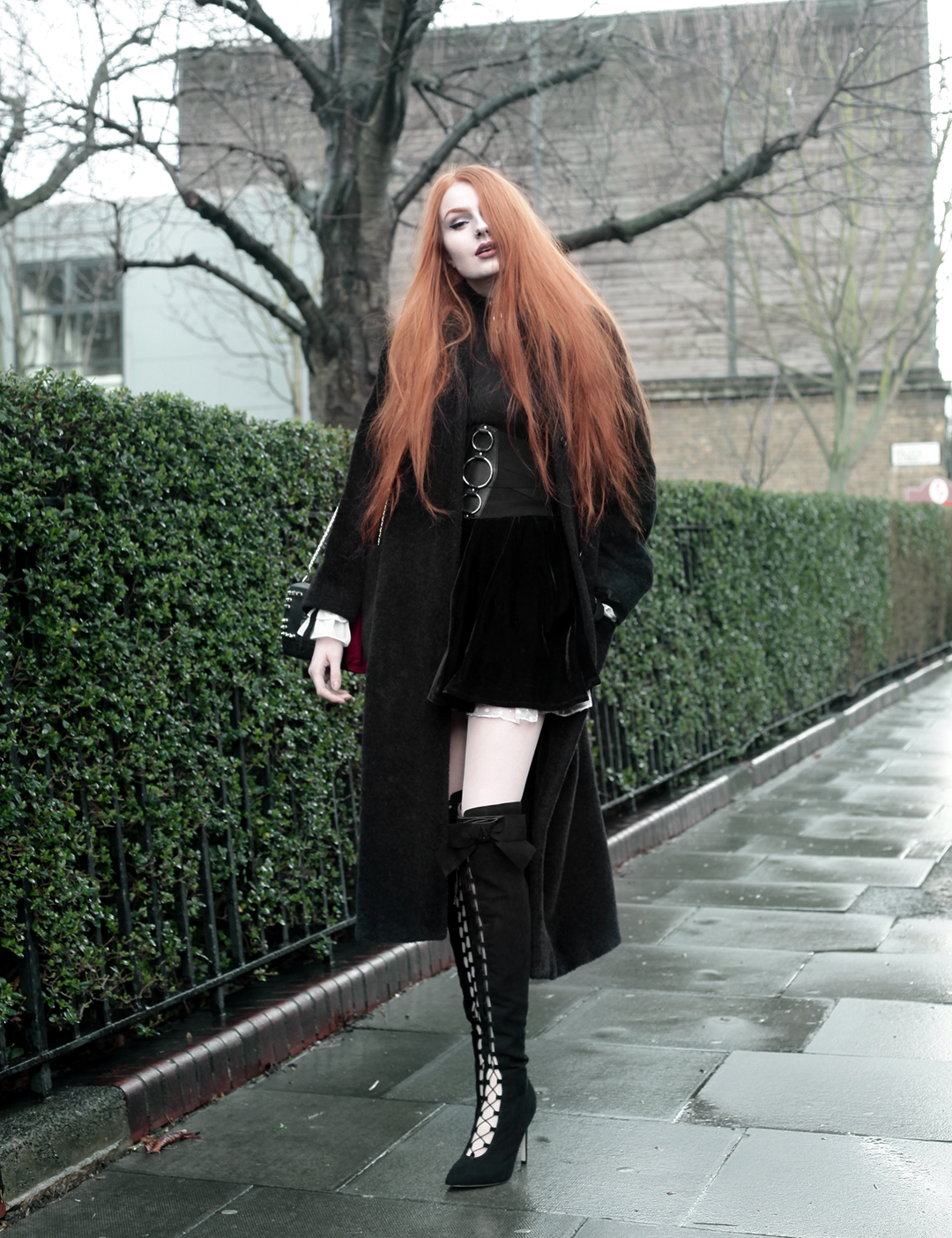 Olivia Emily wears Skinny Bags Dark Thoughts Clutch, Vintage Max Mara coat, Asos Lace Up Boots, and Asos Corset Belt.