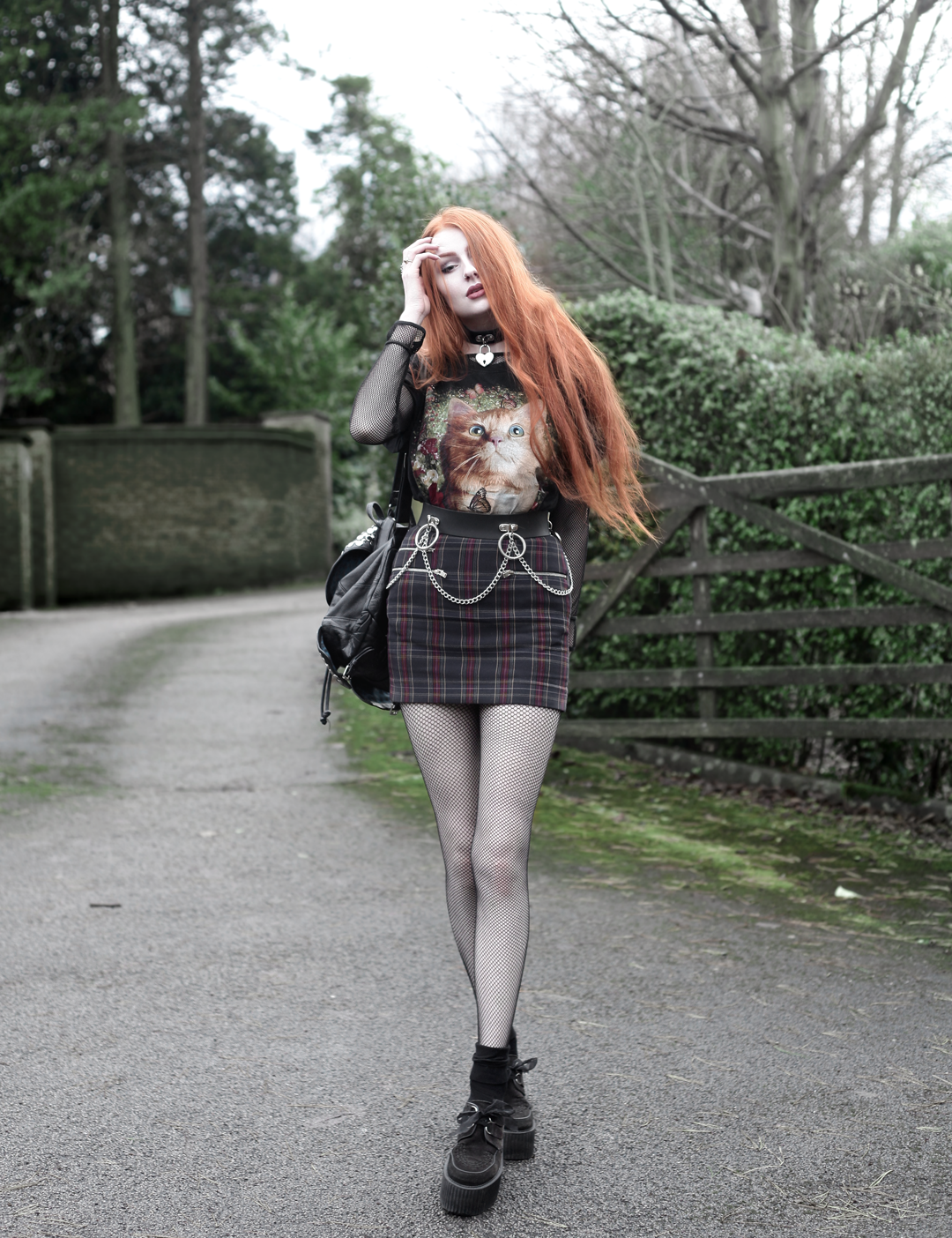 Olivia Emily wears Vintage Cat Tee, fishnet long sleeve top, Mary Wyatt Belt, Plaid Skirt, and Underground Creepers