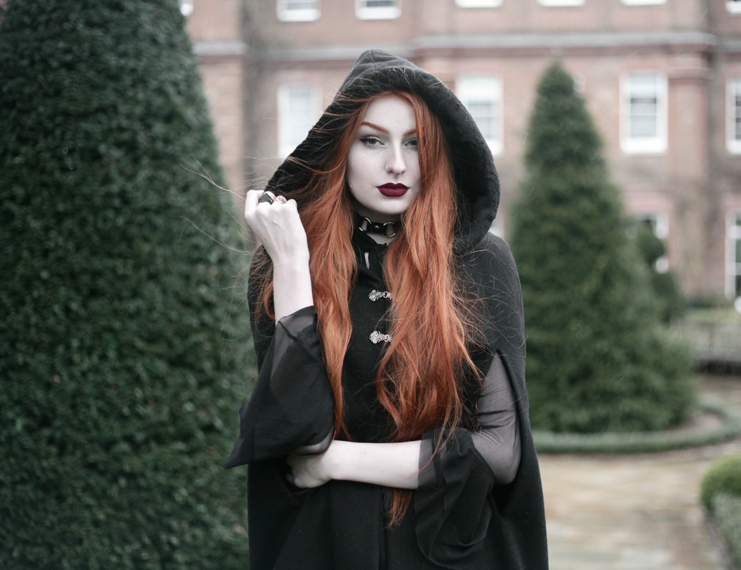 Olivia Emily wears Dark Thorn Clothing Cape, Killstar Nu Decay Dress, and Lime Crime Wicked Velvetine