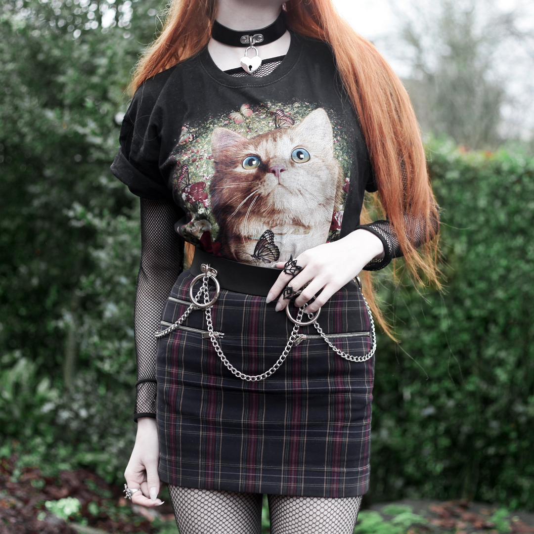 Olivia Emily wears Vintage Cat Tee, fishnet long sleeve top, Mary Wyatt Belt, Plaid Skirt, and Rogue and Wolf Cat Familiar ring