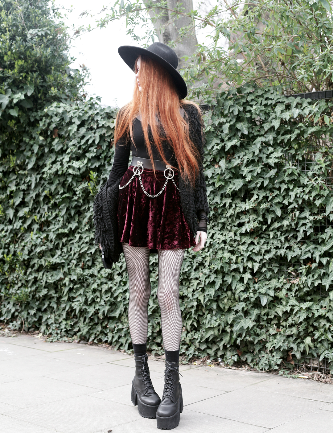 Olivia Emily wears Rogue and Wolf Moondoll Top, Killstar Fedora Hat, Crushed Velvet skirt, Mary Wyatt Chain Belt and Unif Scosche Boots