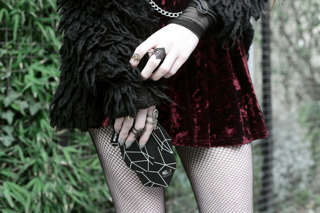 Olivia Emily wears Rogue and Wolf Rings, Killstar Crystal Phone Case, Crushed Velvet skirt, and Mary Wyatt Chain Belt