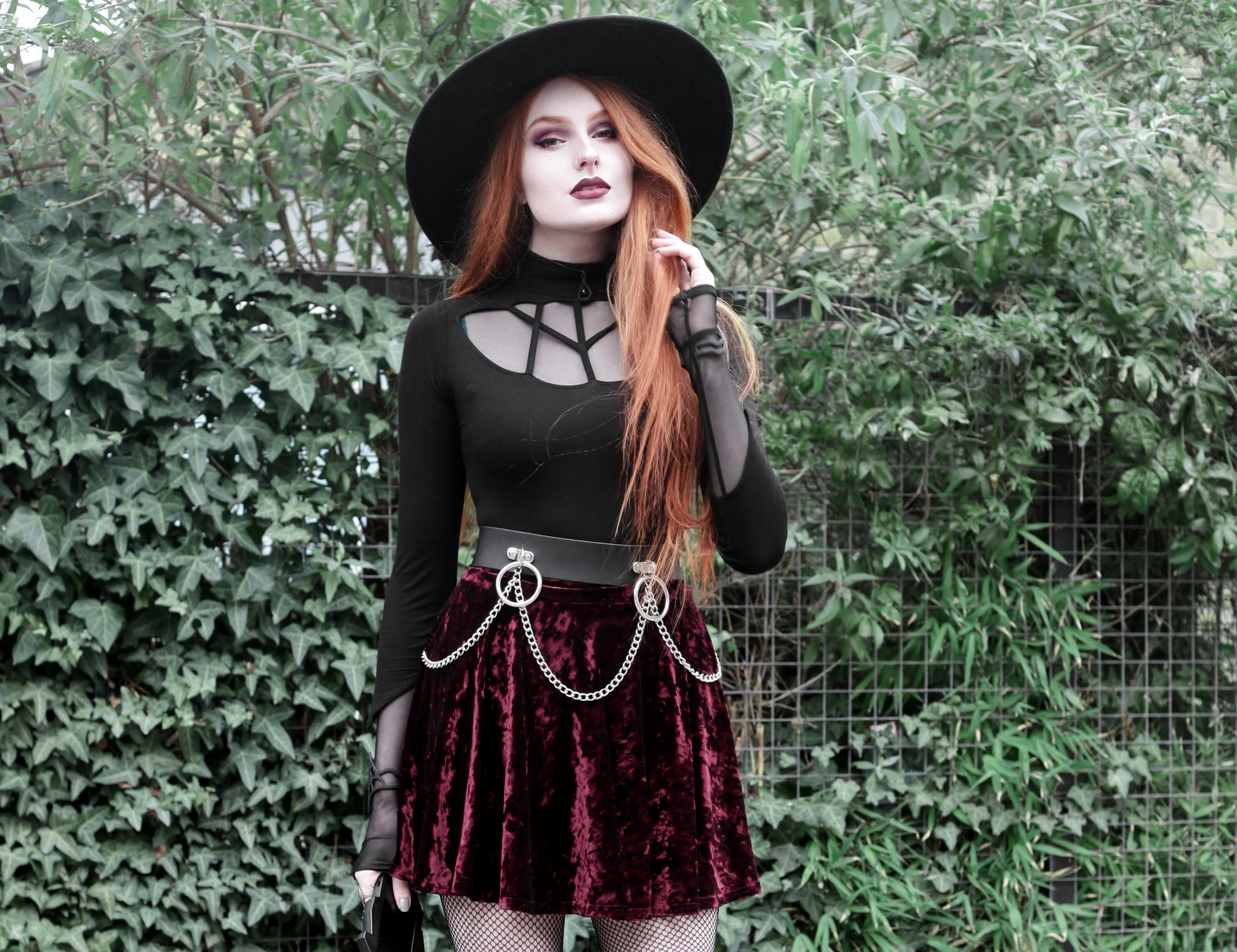 Olivia Emily wears Rogue and Wolf Moondoll Top, Killstar Fedora Hat, Crushed Velvet skirt, and Mary Wyatt Chain Belt