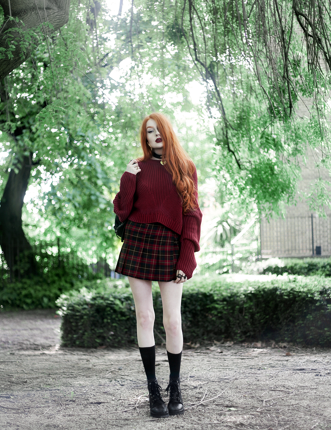 Olivia Emily wears River Island Studio Red Jumper, Topshop red plaid check skirt, Killstar Emily Heart Locket Choker, and Unif Dedi Boots