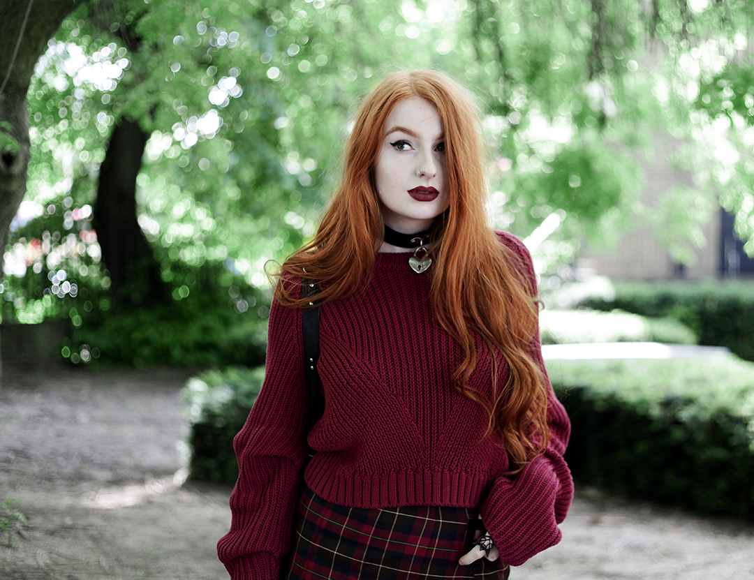 Olivia Emily wears River Island Studio Red Jumper, Topshop red plaid check skirt, Killstar Heart Choker, Killstar Emily Heart Choker and Rogue and Wolf Cat Familiar ring