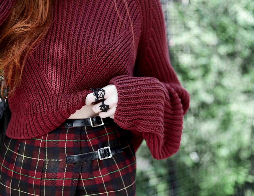 Olivia Emily wears River Island Studio Red Jumper, Topshop red plaid check skirt, Killstar Heart Choker, and Rogue and Wolf Cat Familiar ring