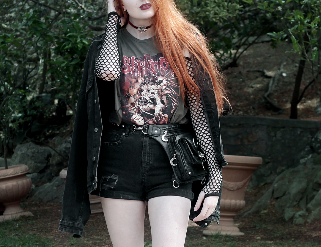 Olivia Emily Wears Slipknot Tank Band Tee, Asos Fishnet Sleeve Bodysuit, Black Denim Shorts, and Regalrose Spiderweb choker