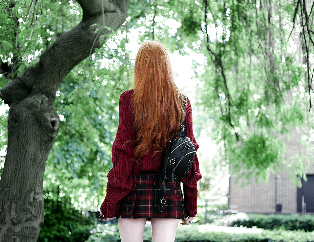 Olivia Emily wears River Island Studio Red Jumper, Topshop red plaid check skirt, and Unif Bound Mini Backpack