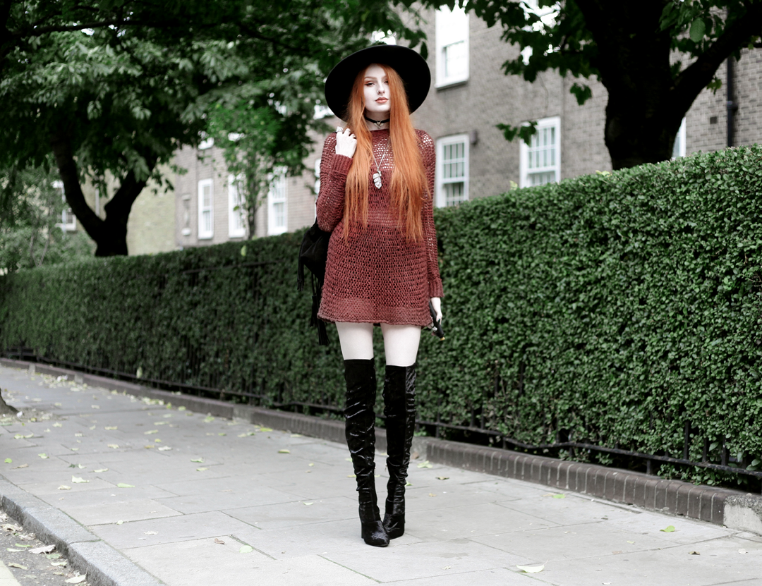 Olivia Emily wears Unif Knit Jumper, Asos Fringe Backpack, Killstar Witch Brim Hat, and Ego Velvet Over Knee Boots