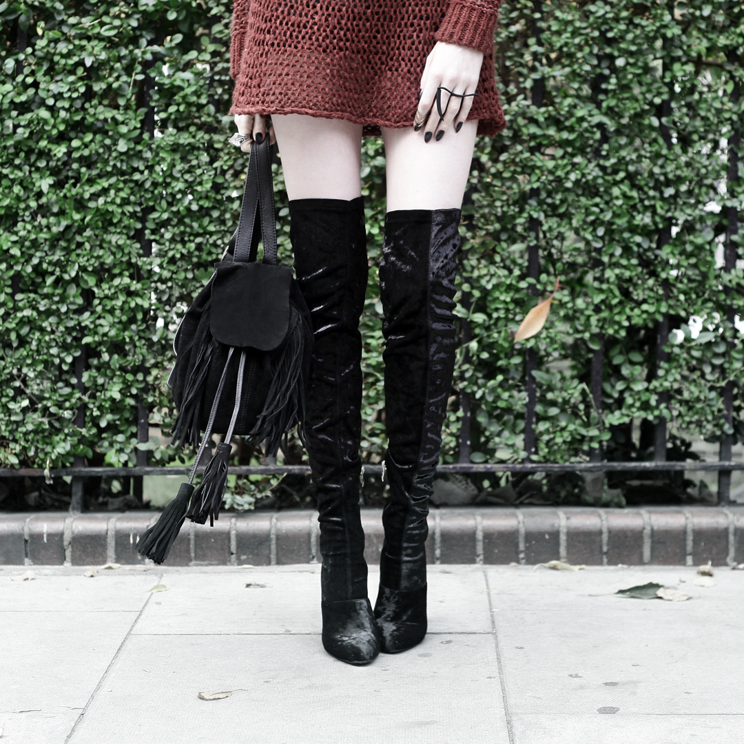 Olivia Emily wears Unif Knit Jumper, Asos Fringe Backpack, and Ego Velvet Over Knee Boots