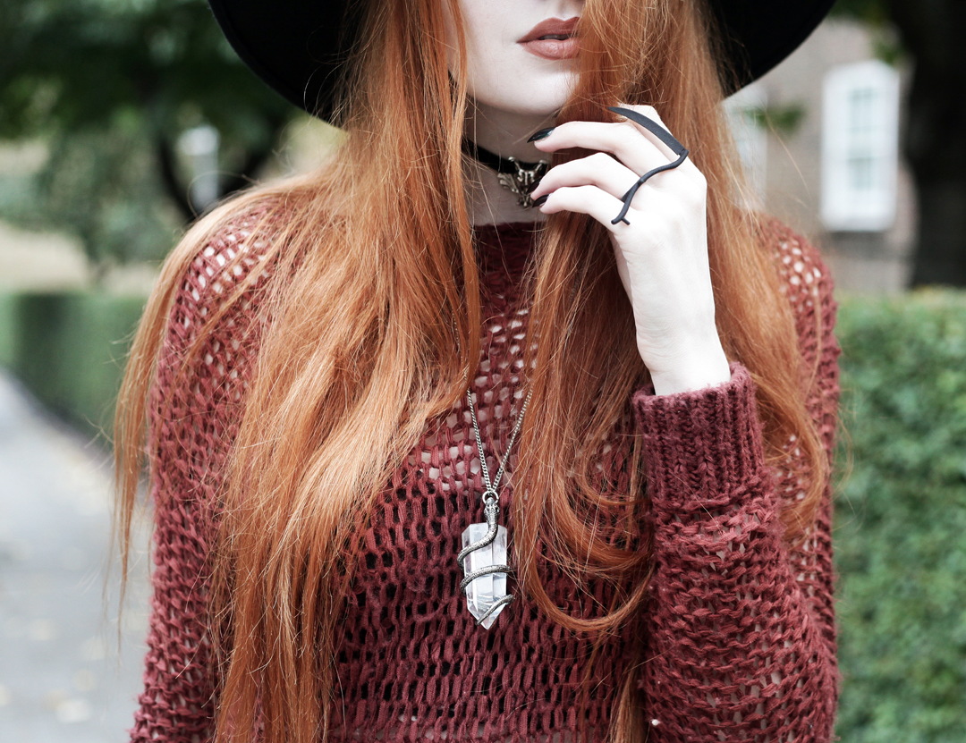 Olivia Emily wears Unif Knit Jumper, Killstar Witch Brim Hat, Rogue and Wolf Reaper Ring, and Killstar Serpent Quartz Necklace