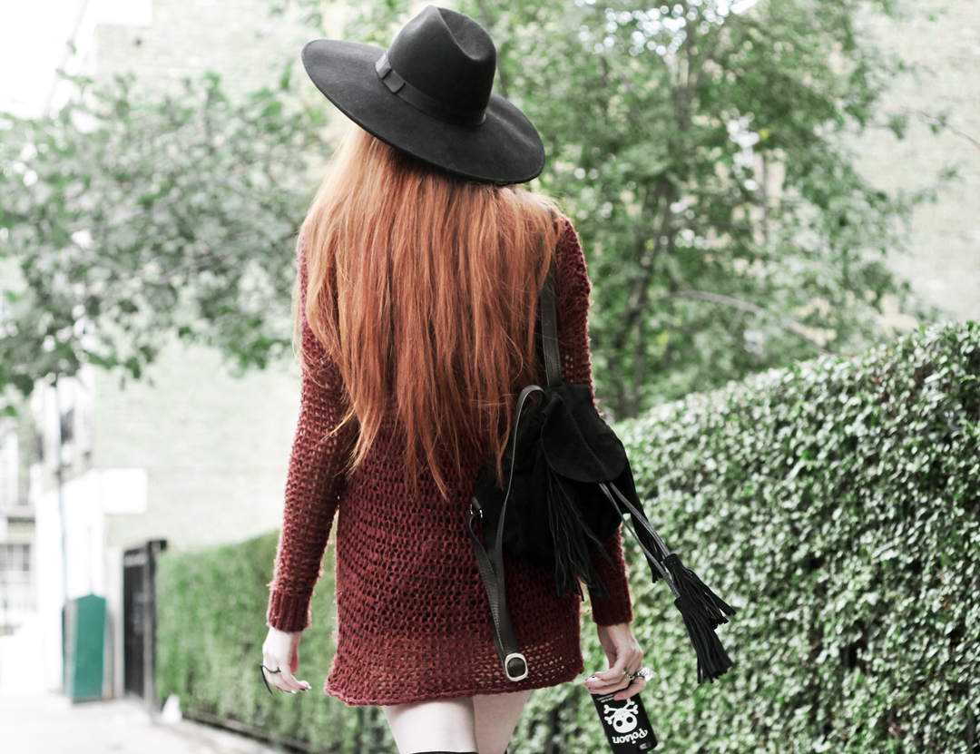 Olivia Emily wears Unif Knit Jumper, Asos Fringe Backpack, Killstar Witch Brim Hat, and Valfre Poison Bottle Phone Case