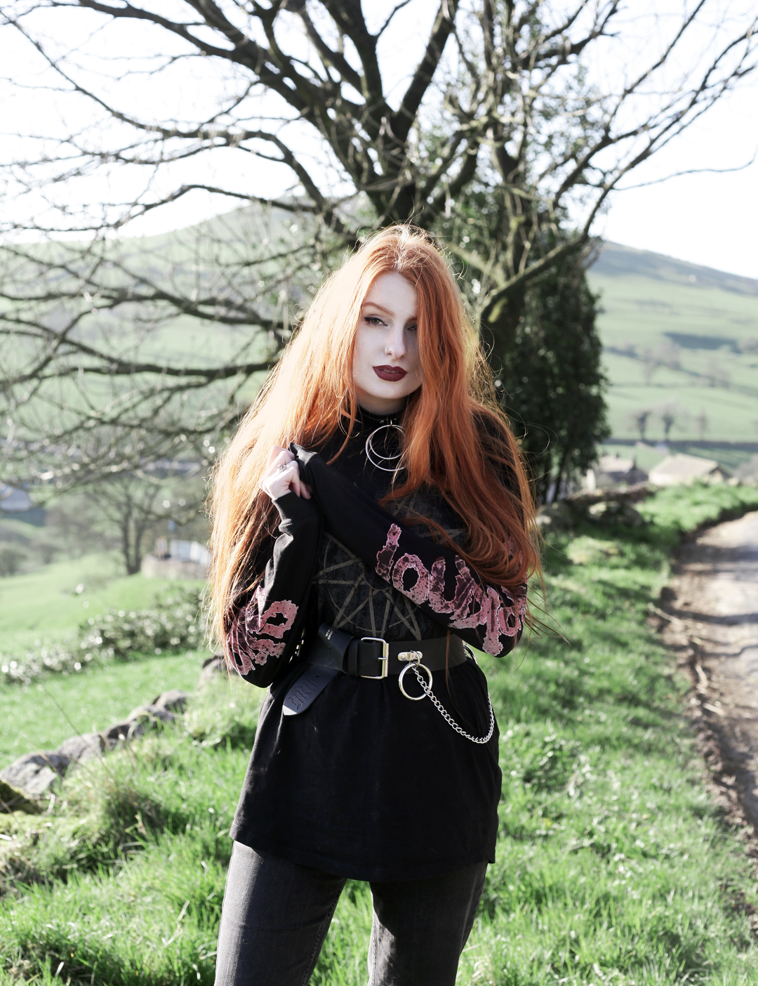 Olivia Emily wears Slipknot Band Tee, Mary Wyatt Chain Belt and Asos ripped straight leg jeans