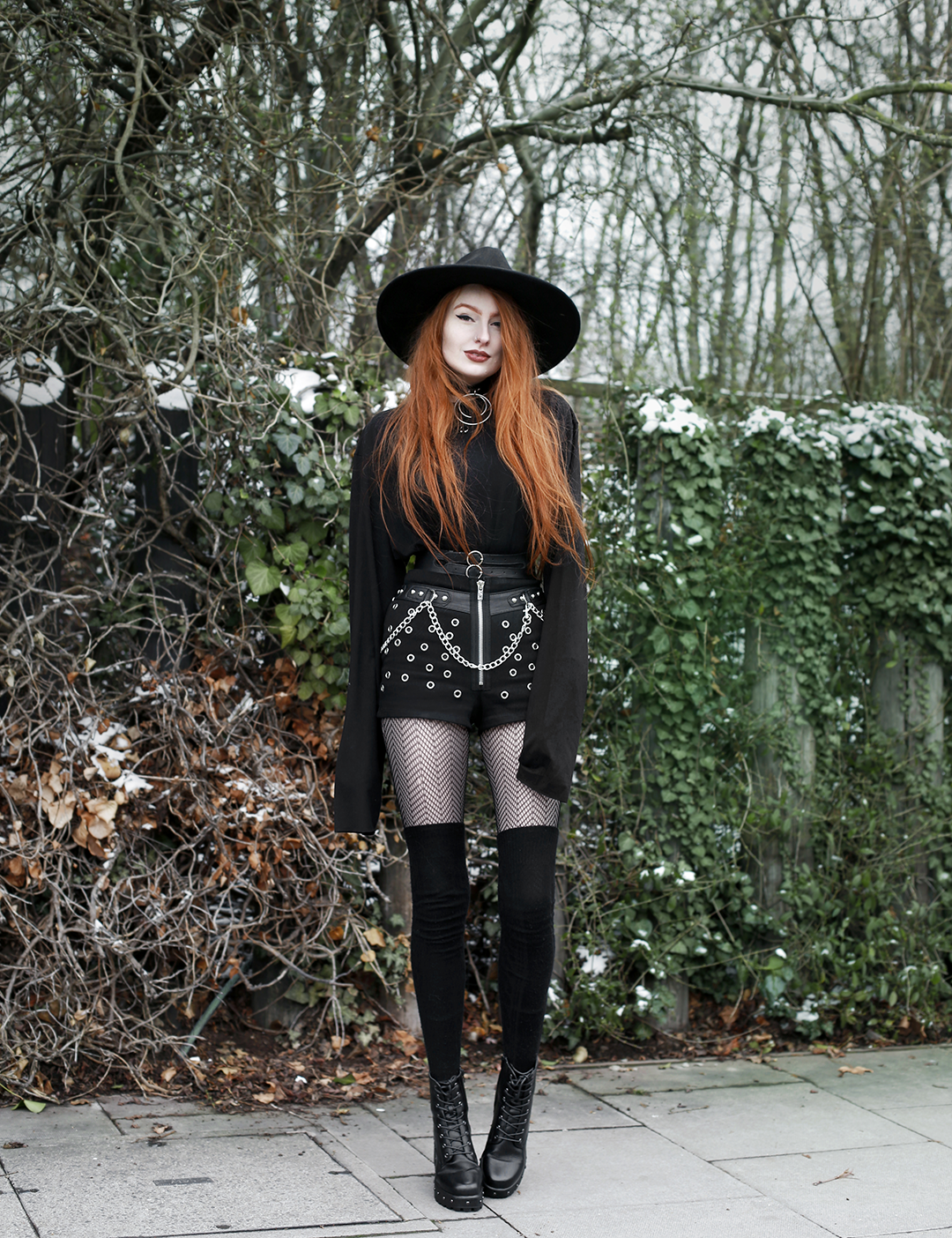 Olivia Emily styles up statement studded shorts for colder temperatures with cosy overknee socks and an oversized top