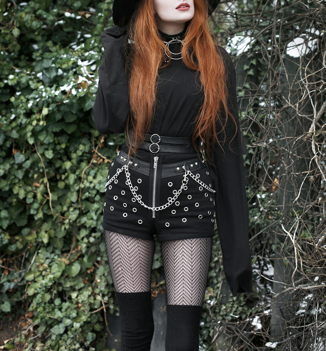 Olivia Emily styles up statement studded shorts for colder temperatures with cosy overknee socks and an oversized top